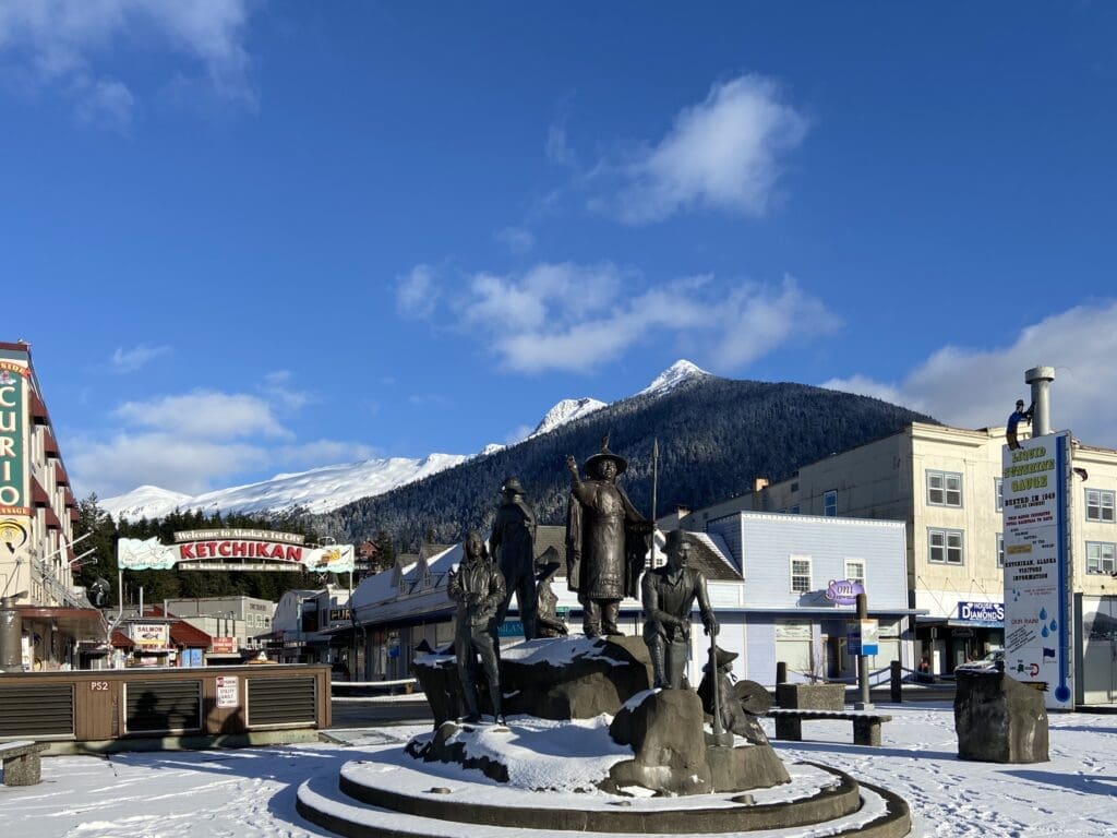 The Rock and Rain Gauge The Rock statue at Berth 2 in downtown Ketchikan with the rain gauge, welcome sign, and Deer Mountain in the background